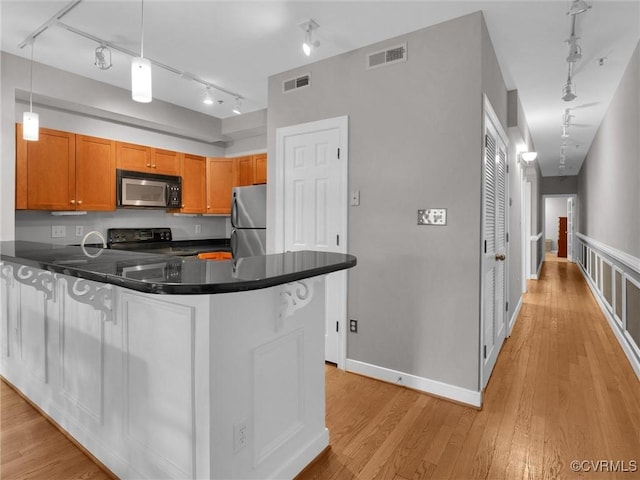 kitchen with black range with electric cooktop, visible vents, track lighting, and freestanding refrigerator