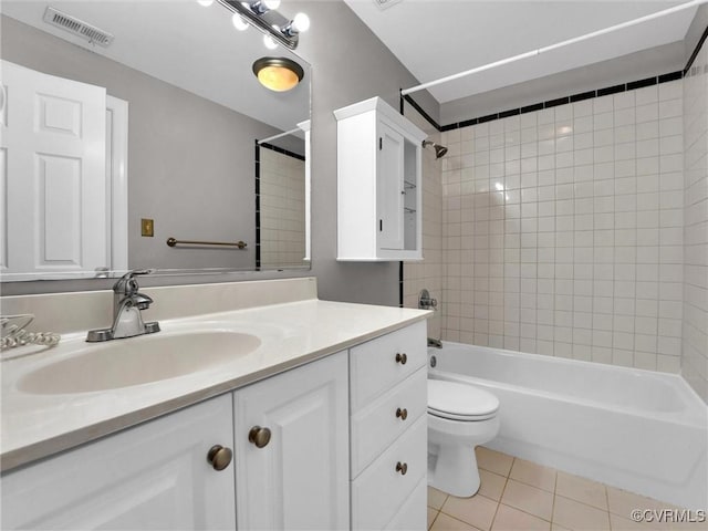 bathroom with tile patterned flooring, toilet, vanity, visible vents, and tub / shower combination