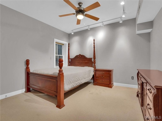 bedroom with light carpet, a ceiling fan, and baseboards