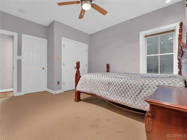 bedroom with ceiling fan, carpet flooring, and baseboards