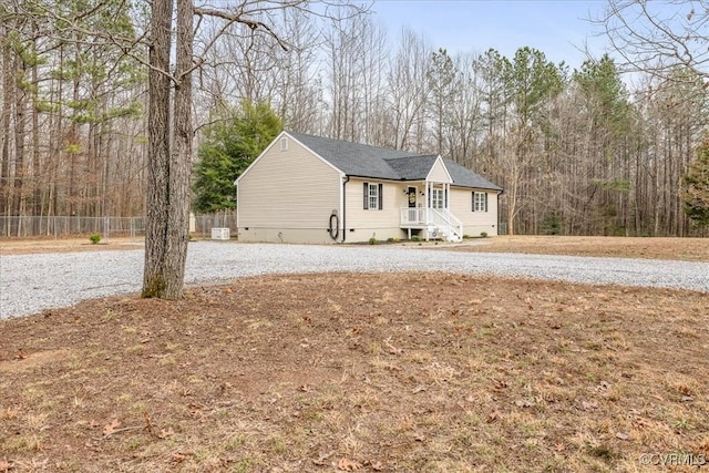 view of front of property featuring crawl space and fence