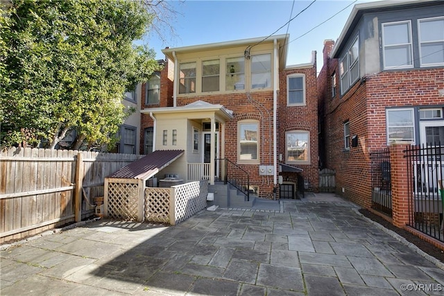 view of front of home with fence and brick siding