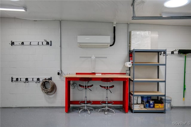 interior space featuring concrete block wall and a wall mounted AC