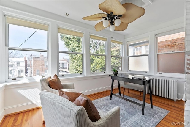 sunroom / solarium with radiator and ceiling fan