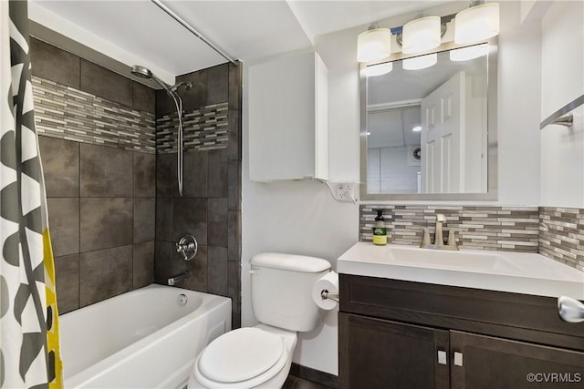 bathroom featuring tasteful backsplash, vanity, toilet, and shower / bath combo with shower curtain