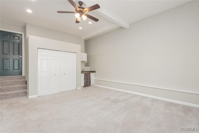 unfurnished bedroom with light carpet, beamed ceiling, recessed lighting, and baseboards