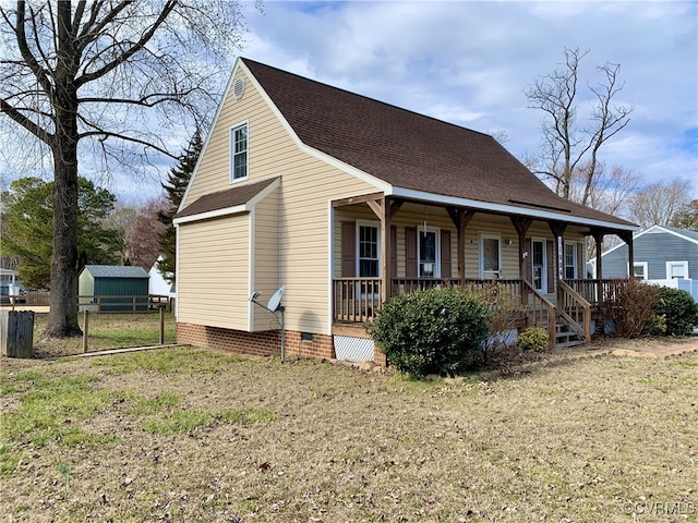 view of front of property with covered porch, a shingled roof, crawl space, and a front yard