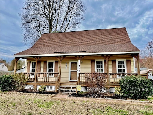 view of front of property with a porch and roof with shingles