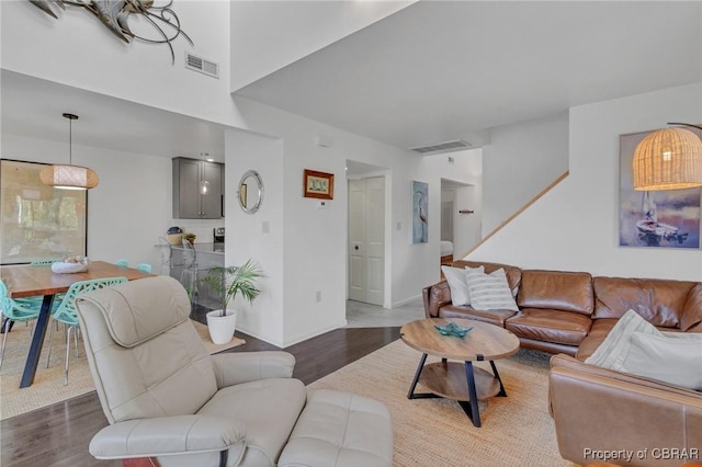 living room with visible vents and wood finished floors