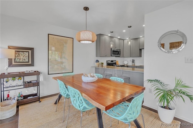 dining area with recessed lighting, baseboards, and light wood-style floors