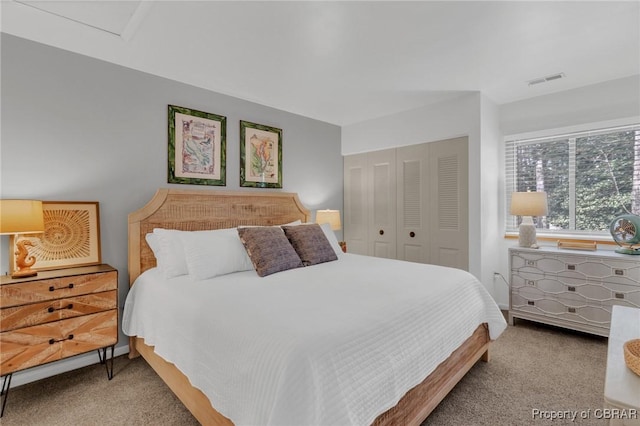 carpeted bedroom featuring visible vents and a closet