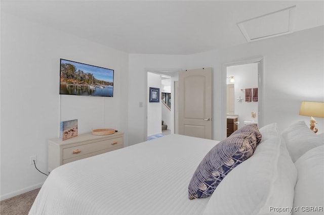 bedroom with carpet flooring, connected bathroom, attic access, and baseboards