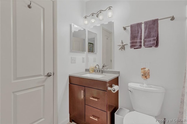 bathroom featuring toilet and vanity