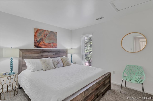 bedroom with attic access, carpet flooring, baseboards, and visible vents