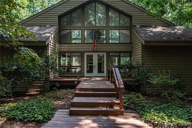 back of house with french doors and a shingled roof