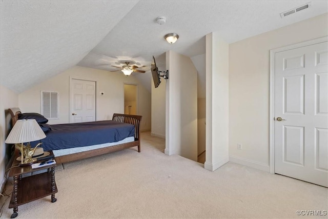 bedroom featuring carpet, visible vents, and a textured ceiling