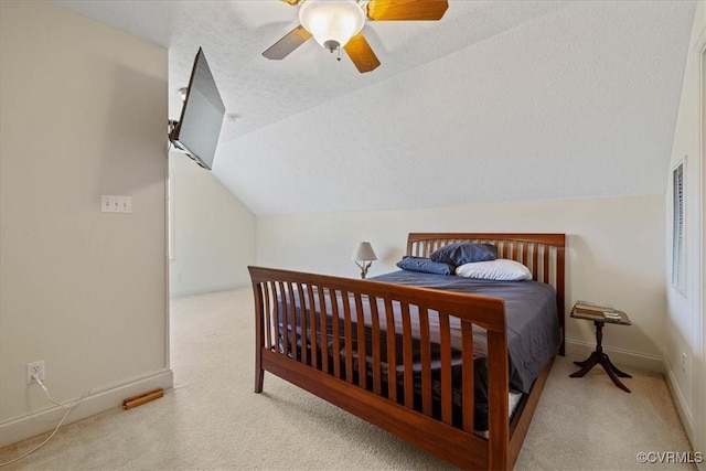 bedroom featuring carpet floors, baseboards, vaulted ceiling, and a textured ceiling