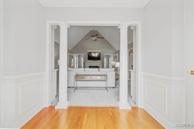 interior space featuring wood finished floors and ornate columns