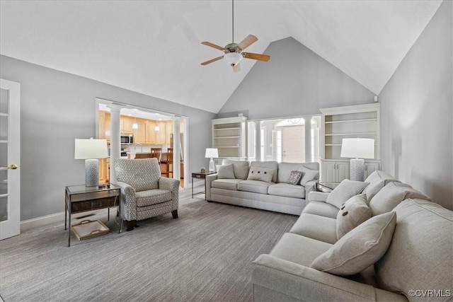 living room featuring high vaulted ceiling, carpet flooring, a ceiling fan, and baseboards