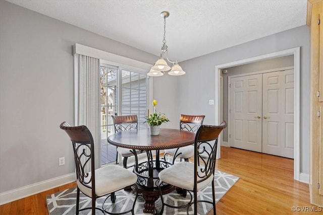 dining room with light wood-type flooring and baseboards