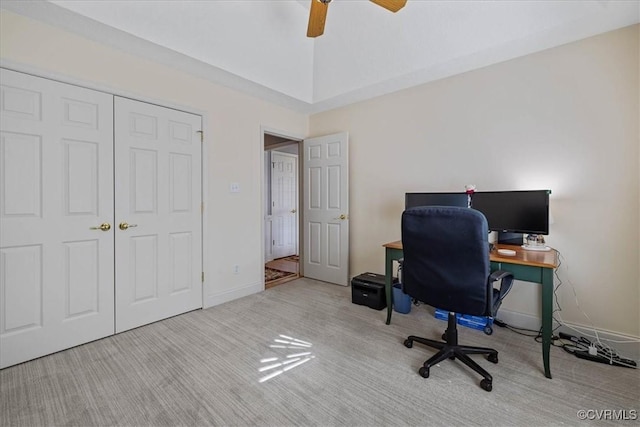 carpeted office with vaulted ceiling, a ceiling fan, and baseboards