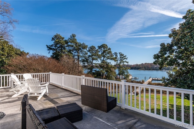 view of patio with a water view and a boat dock