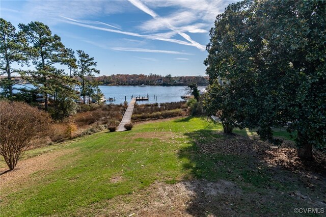 view of yard with a dock and a water view