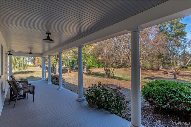 view of patio with ceiling fan and a porch