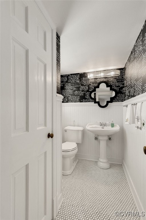 bathroom with toilet and wainscoting