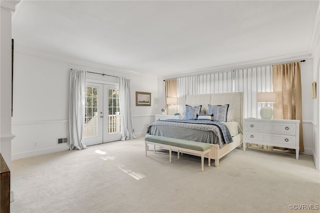 carpeted bedroom featuring access to outside, visible vents, crown molding, and french doors