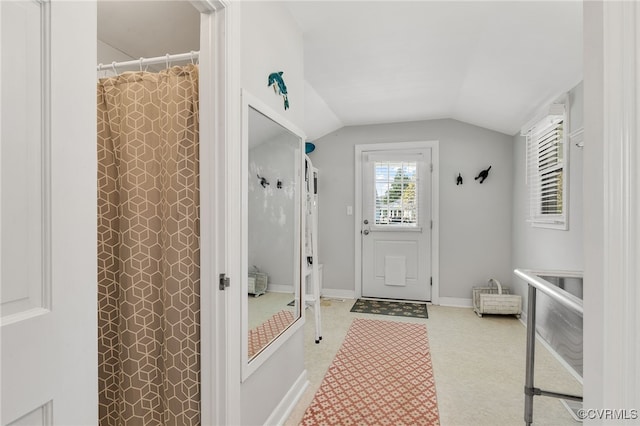 mudroom with vaulted ceiling and baseboards