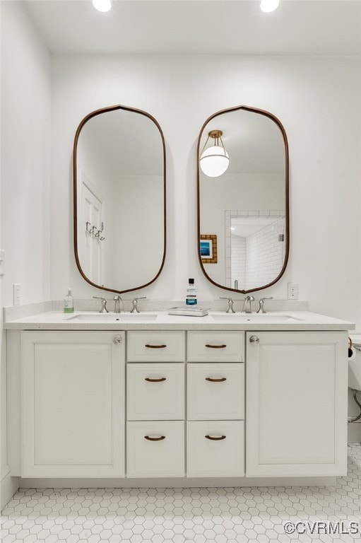 bathroom featuring double vanity, recessed lighting, a sink, and tile patterned floors