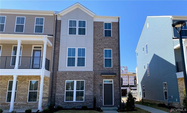 multi unit property featuring brick siding and board and batten siding