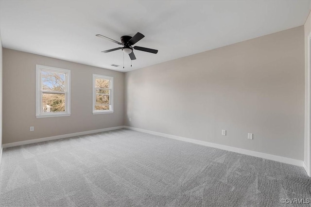 unfurnished room with ceiling fan, baseboards, and carpet flooring