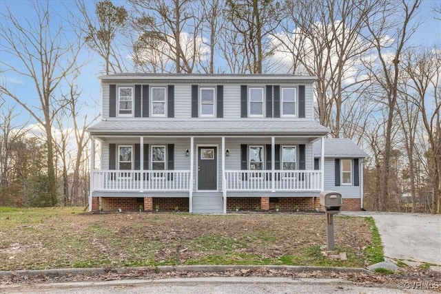 view of front of house with a shingled roof and covered porch