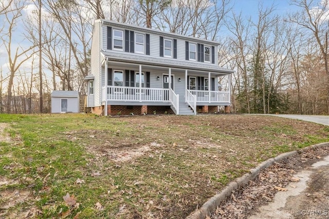 colonial inspired home featuring an outbuilding, a storage shed, and a porch