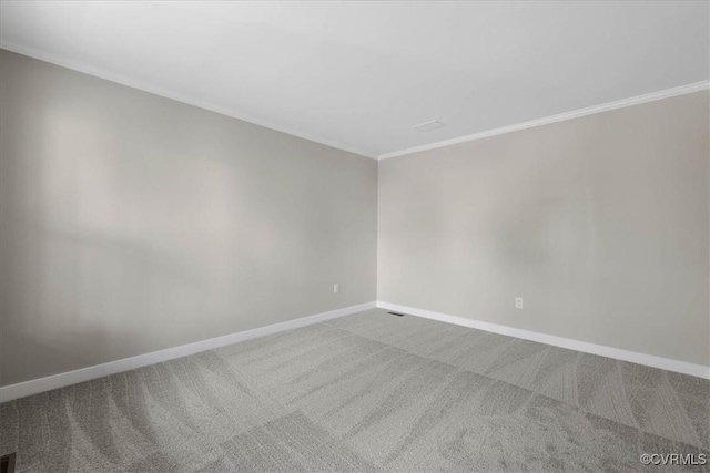 unfurnished room featuring carpet floors, ornamental molding, and baseboards