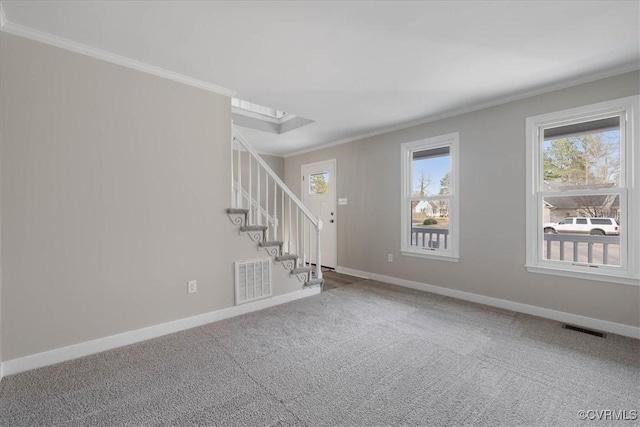 carpeted empty room featuring stairs, ornamental molding, visible vents, and baseboards