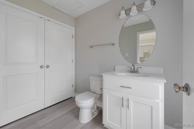 bathroom featuring vanity, toilet, and wood finished floors