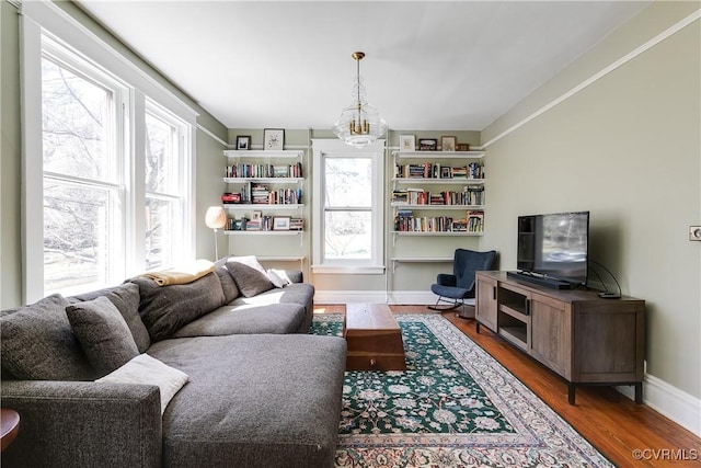 living area featuring baseboards and wood finished floors