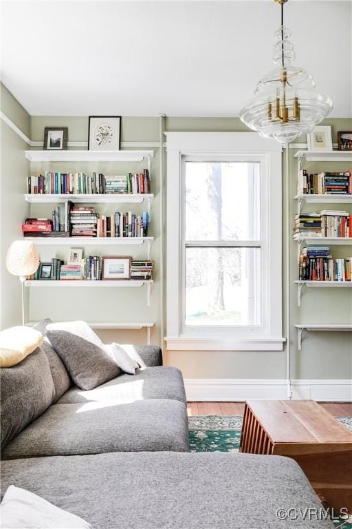 living area with baseboards and wood finished floors