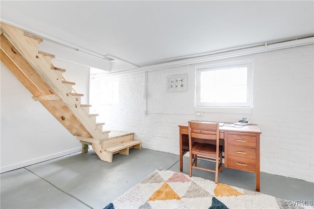 interior space with stairway and brick wall