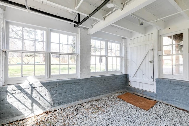 interior space with a wealth of natural light and brick wall