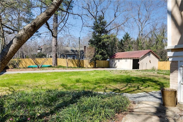 view of yard with a storage shed, an outdoor structure, and fence