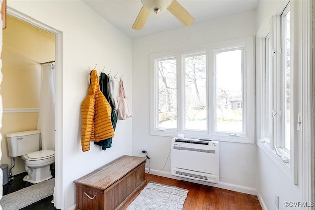 mudroom with heating unit, ceiling fan, dark wood-type flooring, and baseboards