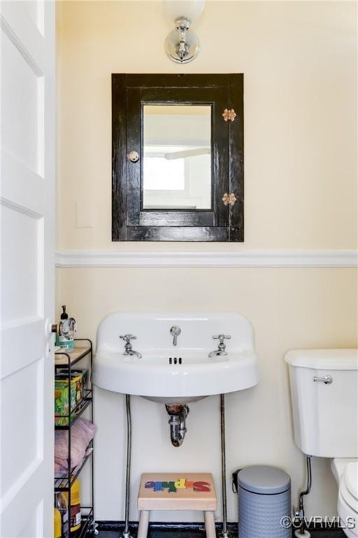 half bathroom with toilet and a sink