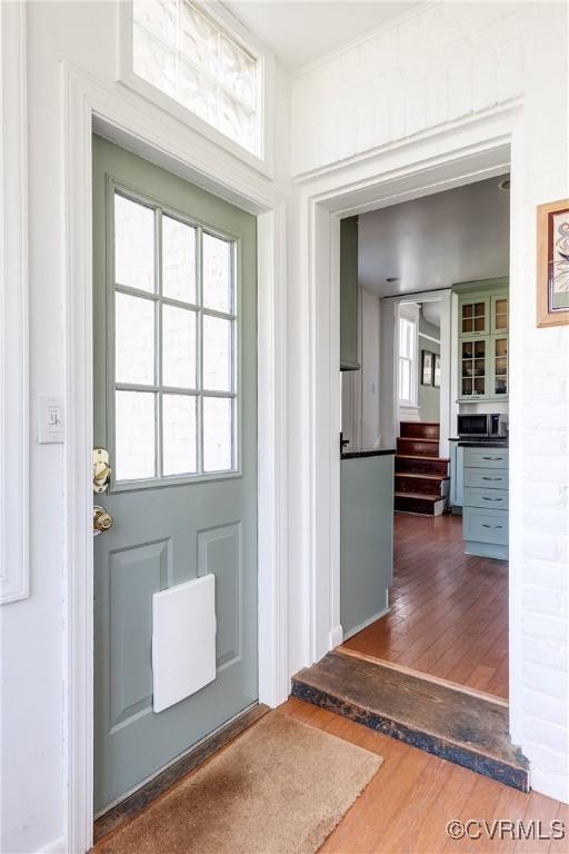 doorway featuring stairs and wood finished floors