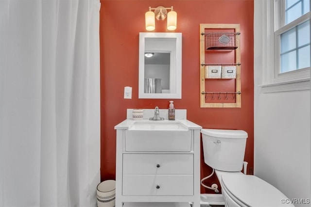 bathroom featuring toilet and vanity