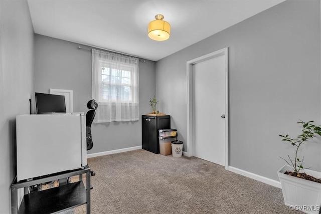 carpeted office space featuring baseboards