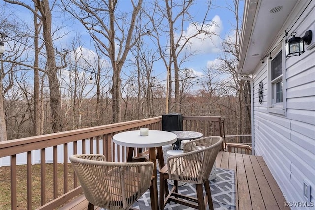 wooden deck with outdoor dining area